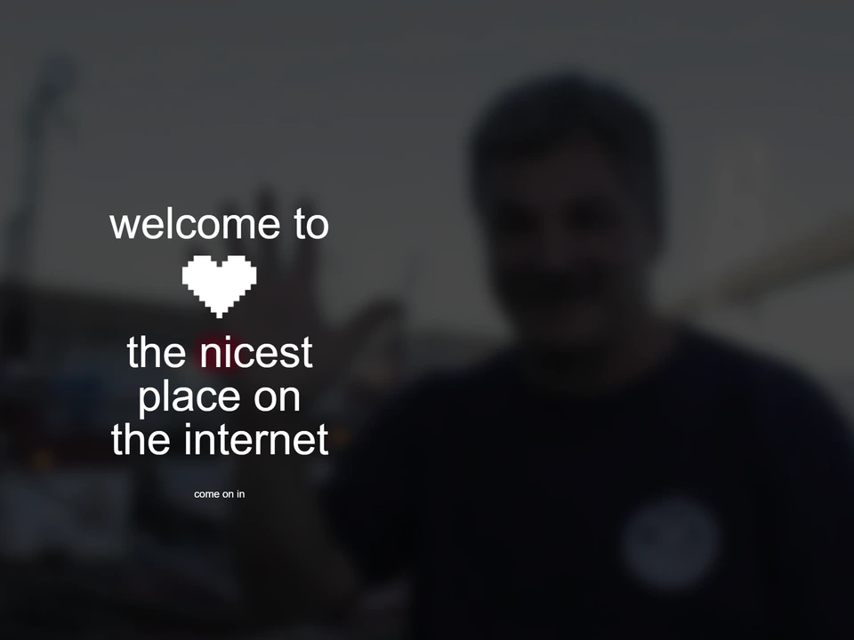 Blurred webpage with the text “welcome to the nicest place on the internet,” a pixelated heart icon, and a small “come on in” invitation over a dark background.