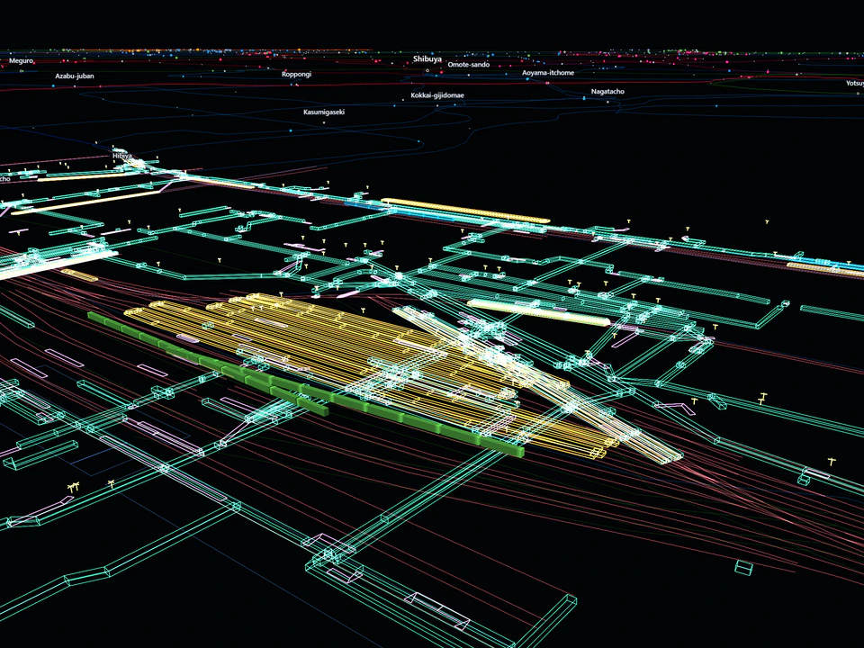 Detailed 3D view of a Tokyo railway station complex, with dense multilevel tracks, platforms, and passageways rendered in bright colored lines against a dark background.