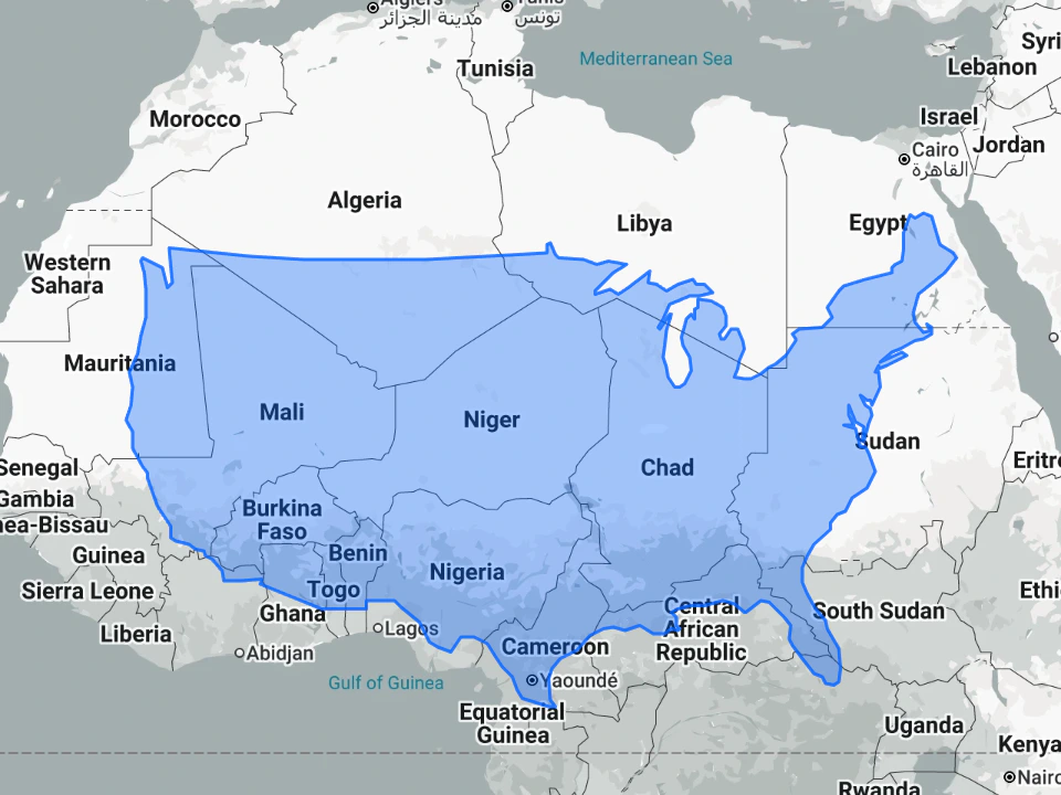 Map of Africa with a translucent blue outline of the contiguous United States overlaid across the continent, illustrating how large the U.S. would appear when placed over western and central Africa.
