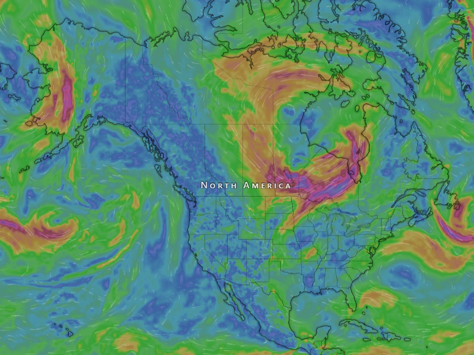 Colorful weather visualization centered on North America, with swirling green, blue, yellow, and red atmospheric patterns showing large-scale wind systems.